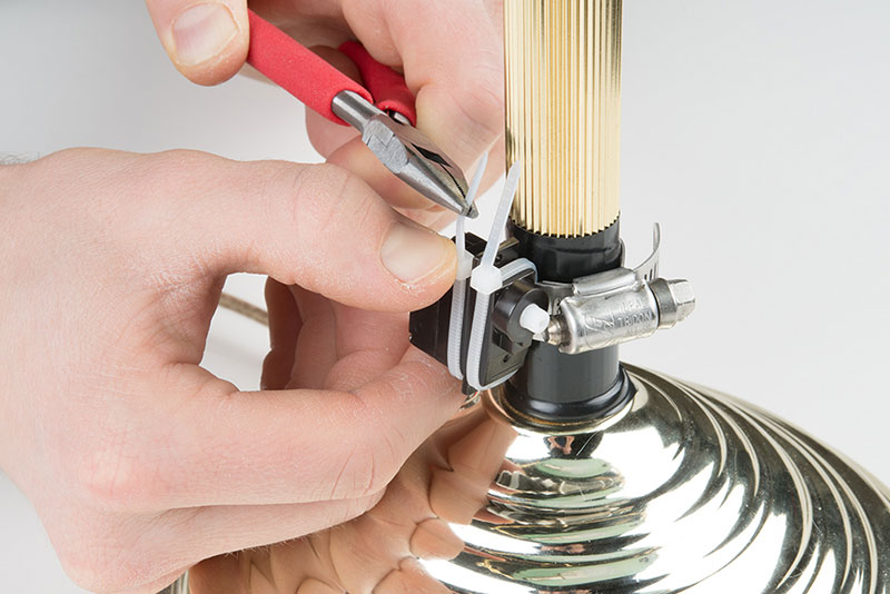 Carefully pull zip ties around the servo